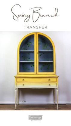 a yellow china cabinet sitting on top of a hard wood floor next to a white wall