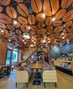 the interior of a restaurant with wooden ceilinging and lights hanging from it's ceiling