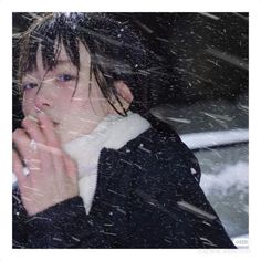 a woman standing in the snow with her hand on her mouth