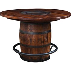 a wooden barrel table sitting on top of a white wall