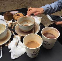 three cups of coffee are sitting on a table