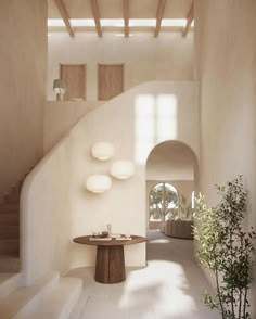 the interior of a modern house with white walls and flooring is lit by natural light