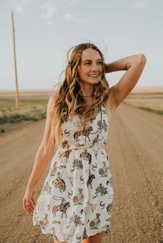 A Cactus Cowgirl Exclusive! The Darlin' Dress is the cutest short summer dress for rodeos, concerts, BBQ's and summer activities! Cream-colored with a cute western pattern. This dress is running true to size. Models are wearing the small and are both 5'4. See size chart below for dress length. Square neckline Fixed straps Zipper closure in the back Elastic waist Very lightweight Lined Size Dress Length (shoulder to bottom of dress) Small 32.5 inches Medium 33.5 inches Large 34.5 inches XLarge 35 Western Summer Dresses, Western Summer Outfits, Western Photo Shoots, Cute Western Outfits, Short Summer Dress, Western Summer, Western Photo, Western Pattern, Brown Cowboy Boots