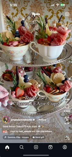 a three tiered tray filled with food on top of a table