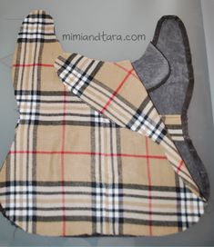 the bib is made out of burber fabric and has a plaid pattern on it