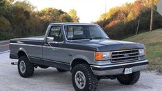 a gray truck parked on the side of a road