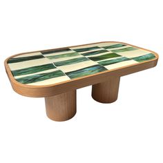 a coffee table with green and white tiles on it's top, in the shape of a checkerboard pattern