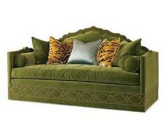 a green couch with some pillows on it