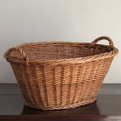 a wicker basket sitting on top of a wooden table