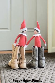 two elfs standing next to each other on the floor with their boots in front of them