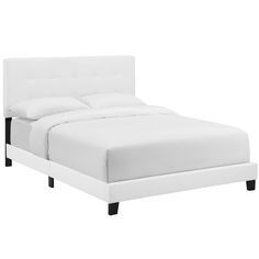 a bed with white linens and black legs