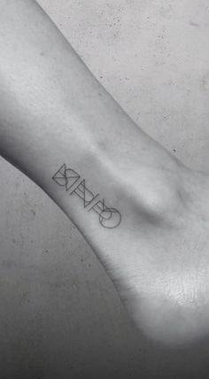 a small black and white tattoo on the left ankle that reads ciara in cursive font