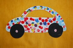 a paper car with polka dots on it