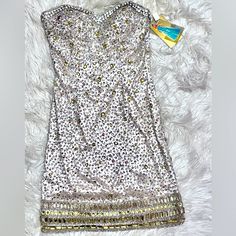 Nwt Lara Design Stunning Strapless Dress. Size 2, Kept Very Meticulously. Covered In Gorgeous Beading, Nude Base Color With Silver And Gold Beads (See Photos). Offers Accepted. Metallic Embellished Sleeveless Mini Dress, Sleeveless Embellished Metallic Mini Dress, Embellished Sleeveless Metallic Mini Dress, Metallic Embellished Sleeveless Dress, Glamorous Festive Dress With Rhinestones, Silver Sleeveless Sequin Dress With Rhinestones, Metallic Strapless Sequin Dress, Metallic Strapless Dress With Sequins, Silver Bedazzled Dress For Gala