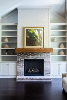 a living room with a fireplace and built in bookshelves