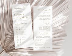 two white wedding programs with palm fronds