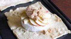 an apple dessert is on a black tray