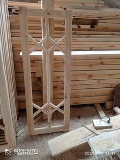 a wooden room divider surrounded by wood planks and plywood flooring boards