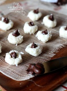 small chocolate chip cookies on a cloth with a knife