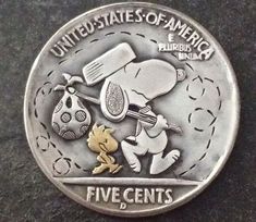 a silver coin with an image of a cartoon character holding a tennis racquet