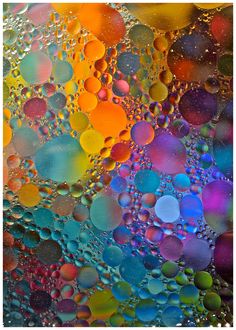 colorful bubbles are seen in this close up photo with water droplets on the bottom and bottom