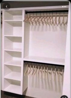 an organized closet with clothes hanging on hooks