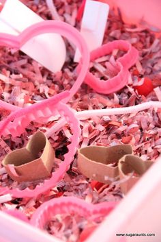 a pink plastic container filled with lots of crafting supplies