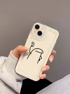 a woman holding up her phone case with a drawing on it