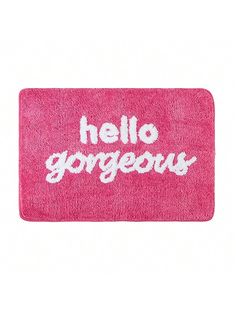 a pink door mat with the words hello gorgeous written in white ink on it, against a white background