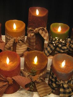 many different colored candles with bows on them