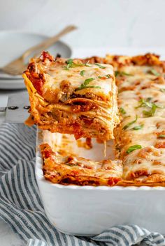 lasagna casserole being lifted with a fork from the casserole dish