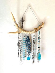 an animal skull with beads and chains hanging from it's side on a wall