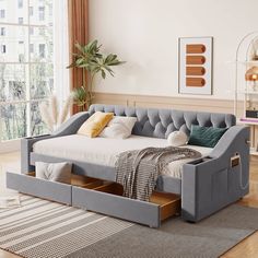 a day bed with drawers underneath it in a living room