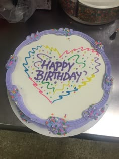 a birthday cake with the words happy birthday written in frosting and sprinkles