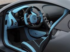 the interior of a blue and black sports car