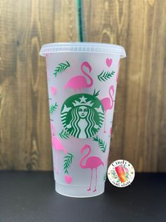 a starbucks cup with pink flamingos on it