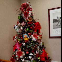 a decorated christmas tree in the corner of a room