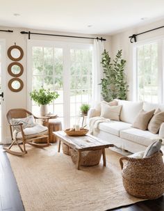 a living room filled with furniture and lots of windows