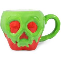 a green and red coffee cup with a skull on it's side, sitting in front of a white background