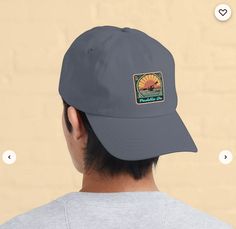 the back of a man wearing a gray hat with a sunset sticker on it