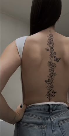 the back of a woman's body with flowers on it