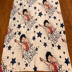 a bed spread with an image of a woman in red and white dancing on stars