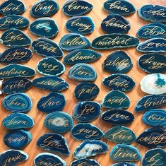 some blue plates with writing on them sitting on a wooden table next to each other