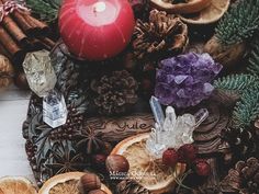 an arrangement of fruit and candles on a table