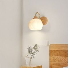 a bedroom with white walls and wooden furniture