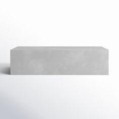 a concrete block sitting on top of a white floor