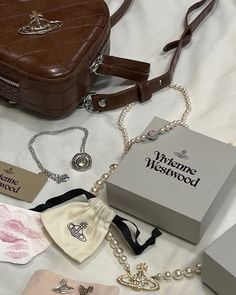 the contents of a women's handbag are laid out on a white sheet