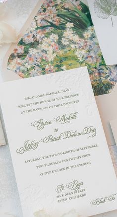 the wedding stationery is laid out on top of each other