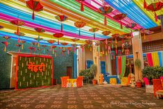 the inside of a building decorated with colorful umbrellas and decorations hanging from it's ceiling