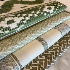 four green and white fabrics stacked on top of each other